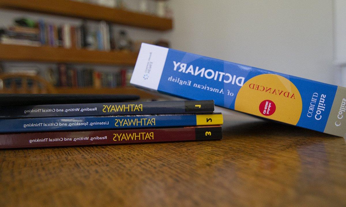 Four books stacked on a table